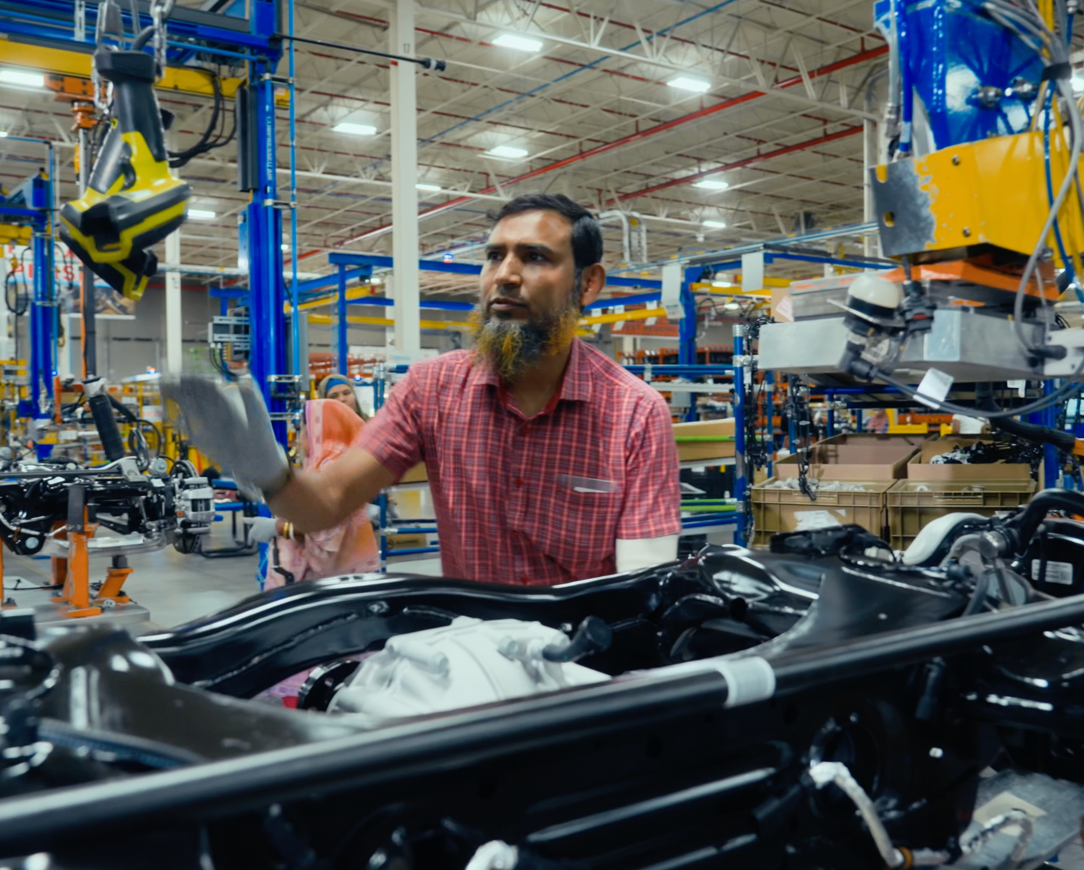 Operator working with assembly tooling on a vehicle system